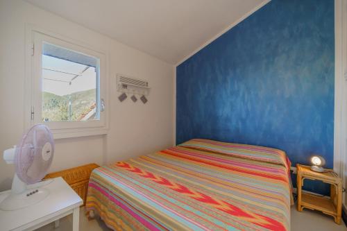 a small bedroom with a bed and a window at Cala Azzurra a Fetovaia - Goelba in Fetovaia
