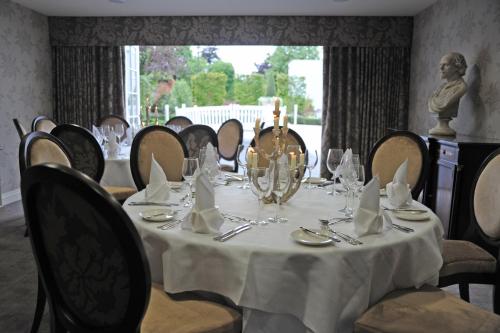 a dining room with a table with a white table cloth at The Arden Hotel Stratford - Eden Hotel Collection in Stratford-upon-Avon