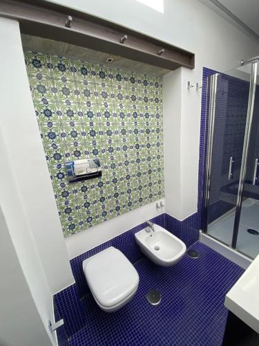 a bathroom with a toilet and a sink at Casa Flora in Vietri sul Mare