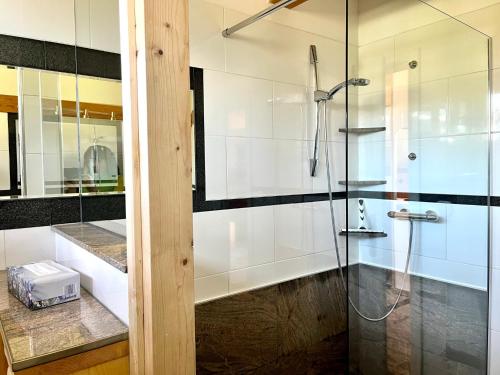 a bathroom with a shower with a glass door at Chalet Magda-Lena in Heiligenblut