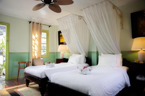 Ένα ή περισσότερα κρεβάτια σε δωμάτιο στο Villa Maly Boutique Hotel