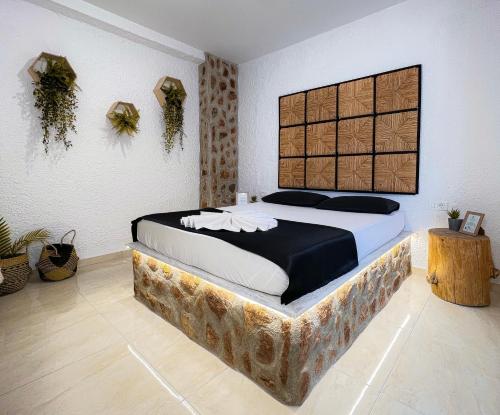 a bedroom with a large bed with a wooden headboard at LA Casa Di Lusso N3 - Adults Only in Kolimbia