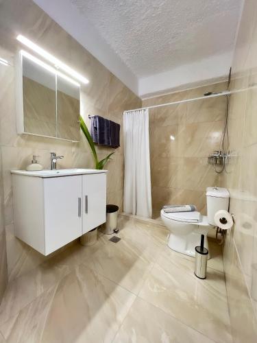 a bathroom with a white sink and a toilet at LA Casa Di Lusso N3 - Adults Only in Kolimbia