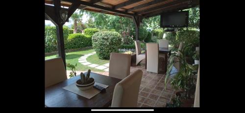 a patio with a table and chairs and a television at Christopher's apartments in Ulcinj