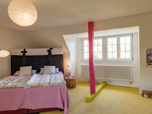 a bedroom with a bed with a red ribbon on it at Romantischer Villenteil in der Barock- und Musikstadt Ochsenhausen in Ochsenhausen