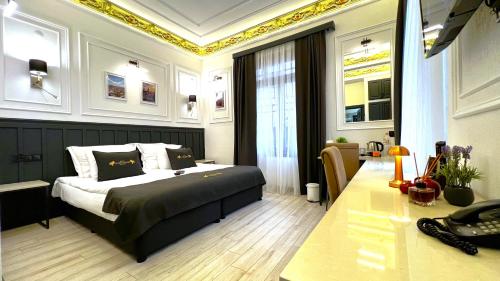 a bedroom with a king sized bed and a desk at Angel's Home Hotel - Angel Group Hotels in Istanbul