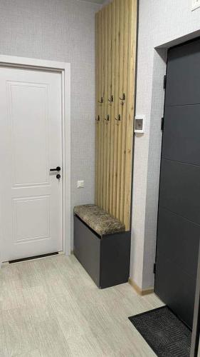 a room with a door and a bench next to a door at Didveli Residence Studio Apartment in Bakuriani