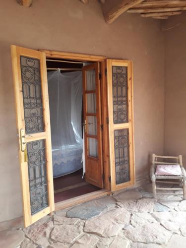 an open door of a room with a bed at Dar Paru in Mhamid