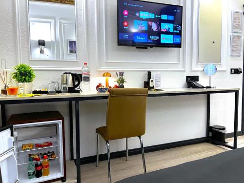 a kitchen with a bar with a television on the wall at Angel's Home Hotel - Angel Group Hotels in Istanbul