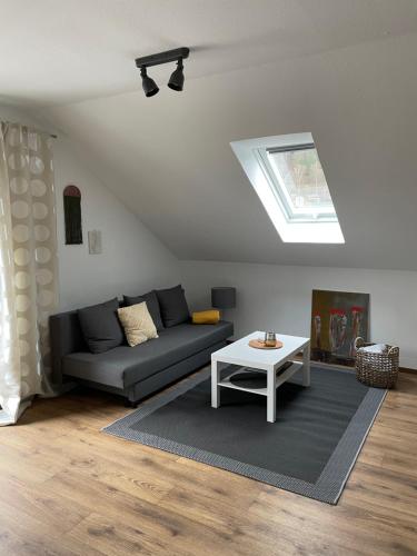 a living room with a couch and a table at Ferienwohnung Ela in Bad Kissingen