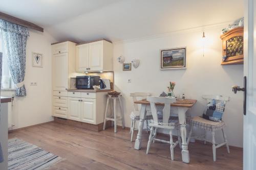 una cucina con tavolo e tavolino con sedie di Haus Victoria a Sankt Gilgen