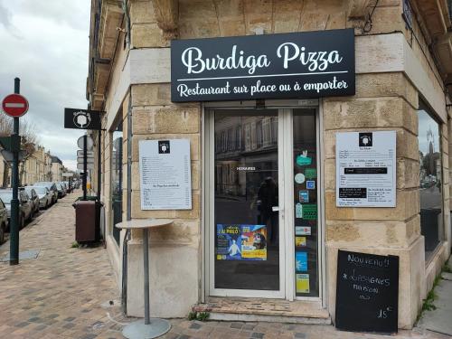 a building with a sign on the side of it at Studio en Duplex-Aircon-Terrasse-Parking-Calme in Bordeaux