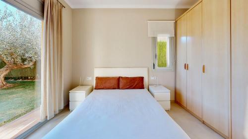 a bedroom with a bed and a large window at Villa Sol in L'Ampolla