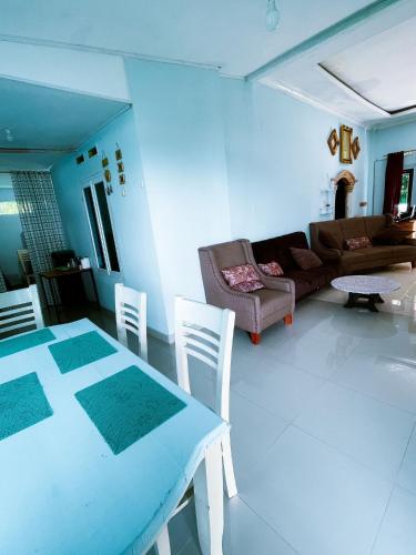 a living room with a table and a couch at The view padang, Amazing view, 8 mins Mentawai fast ferry, cold beer,close to restaurants in Padang