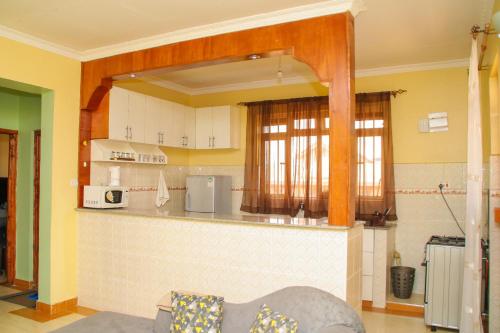 a kitchen with white cabinets and a counter top at GB Homes in Eldoret