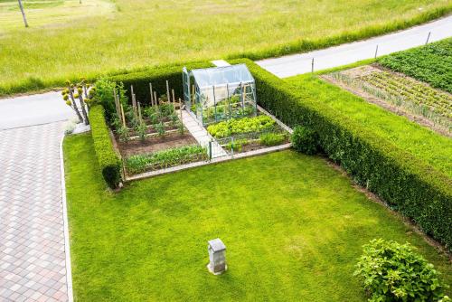 an overhead view of a garden with a greenhouse at Apartma Tia 2 in Zreče