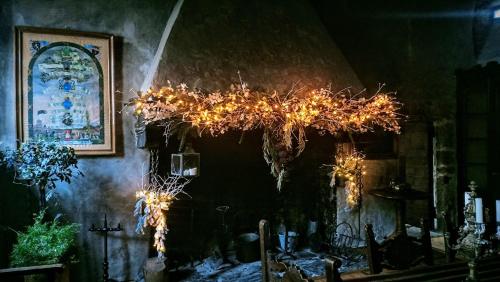 a room with a chandelier with lights on it at B&B La Tour de Villa in Aosta