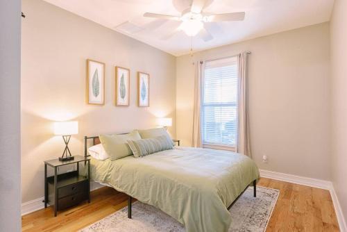 a bedroom with a bed and a ceiling fan at Manassas House 4 BDR Patio Firepit in Tallahassee