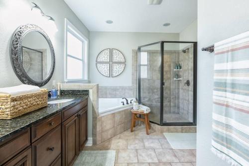 a bathroom with a shower and a sink and a mirror at Manassas House 4 BDR Patio Firepit in Tallahassee