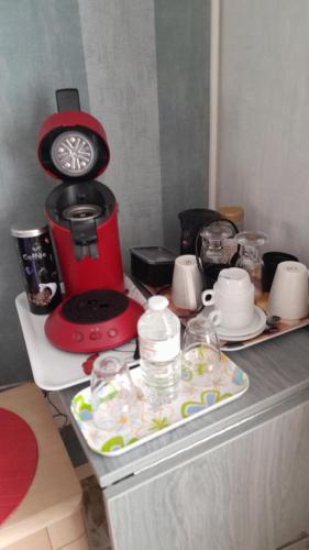 a kitchen counter with a coffee maker on top of it at B & B Vandenbroucke Joseline in Ieper