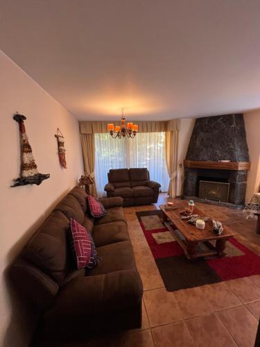 a living room with a couch and a table at Departamento Pucon in Pucón