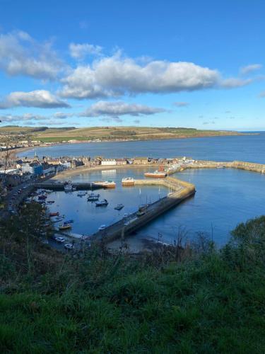 a view of a harbor with boats in the water at ARDUTHIE STREET in Stonehaven