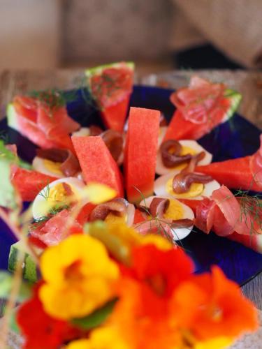 a plate of food with fruits and vegetables on it at Lensmannsgården in Namdalseid