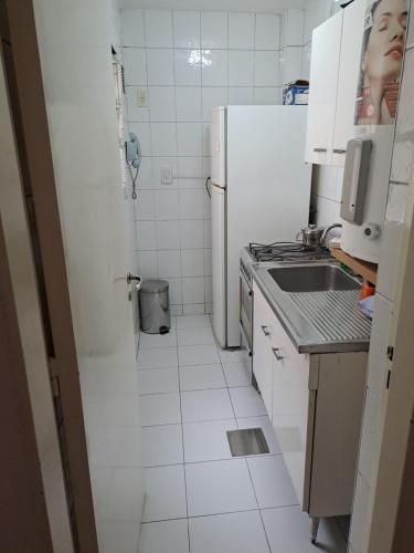 a kitchen with a sink and a refrigerator at Departamento frente a Plaza España in Mendoza