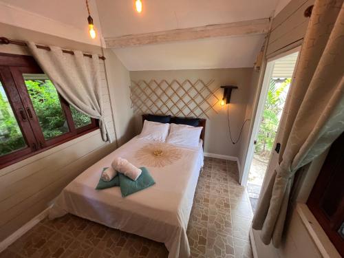 a bedroom with a bed with two towels on it at Sense Asia in Haad Tian