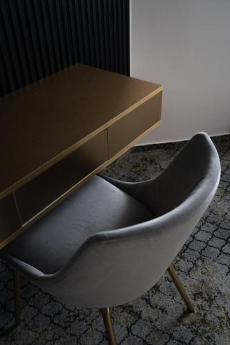 a desk and a chair sitting next to a table at Hotel Cristal in Cluj-Napoca