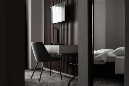 a bedroom with a desk and a chair next to a bed at Hotel Cristal in Cluj-Napoca