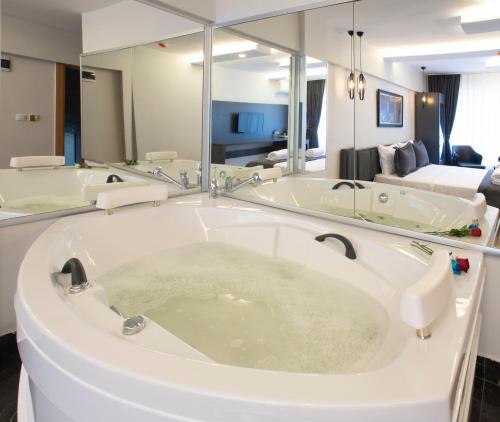 a bathroom with three sinks and a large mirror at Kanarya Suite in Istanbul