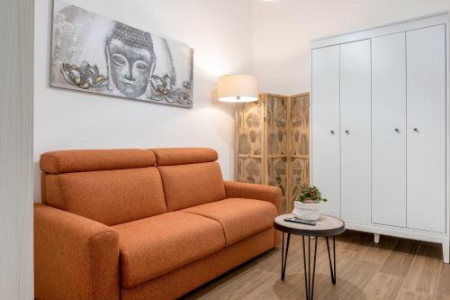 a living room with a couch and a table at Donna Teresa Central & Cozy Apartment in Taranto