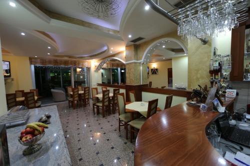a restaurant with a bar and tables and chairs at Villa Maki in Ohrid