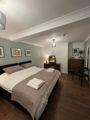 a bedroom with a large bed with two towels on it at Kittiwake Number 4A - Town Centre Ground Floor in Bridlington