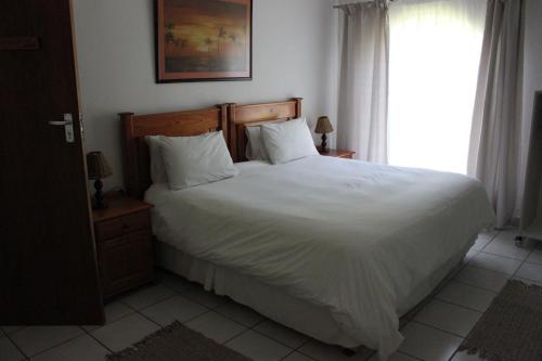 Ένα ή περισσότερα κρεβάτια σε δωμάτιο στο El Palmar Guesthouse