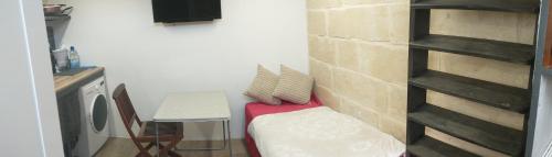 Camera di piccole dimensioni con panchina e tavolo di Cozy room a Birżebbuġa