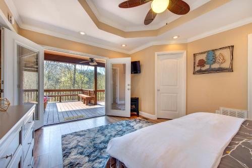 a master bedroom with a bed and a balcony at Rio House Retreat in Tazewell
