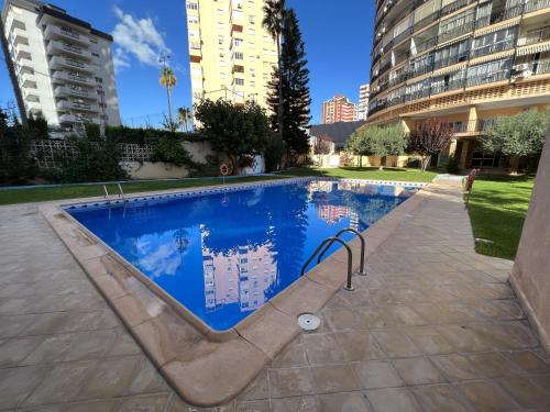 a swimming pool in the middle of a building at Acacias IV 15A in Benidorm