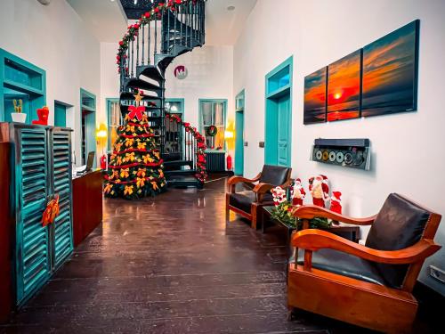a living room with a christmas tree and a staircase at Via Mina Hotel in El Mîna