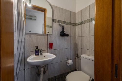 a bathroom with a sink and a toilet and a mirror at Superior apartment LA in Larisa
