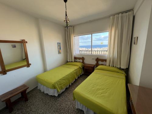 a hotel room with two beds and a window at Acacias IV 15A in Benidorm