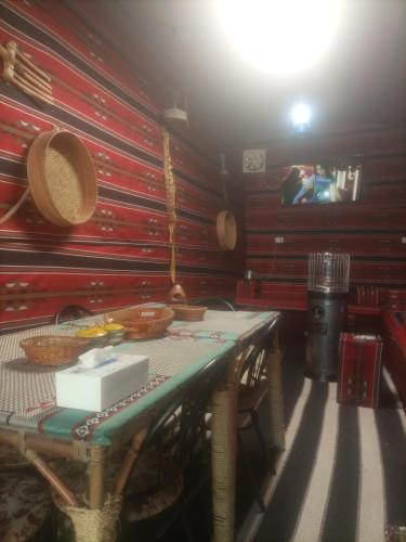 a dining room with a table with baskets on it at Its your choice hostel in Wadi Musa