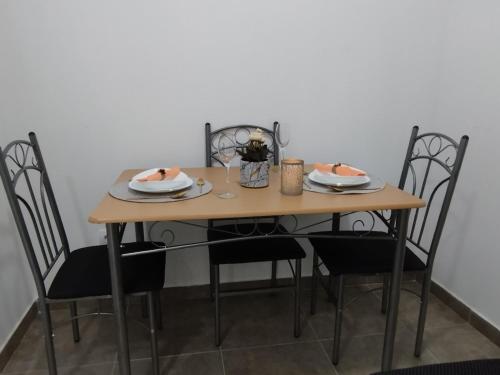 a wooden table with chairs and plates on it at Stan na dan Zvornik in Zvornik