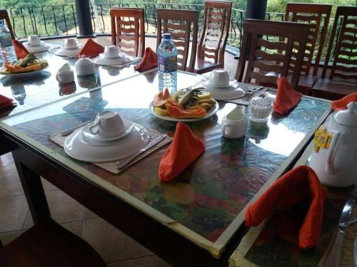 a table with plates of food on top of it at New Kandy Residence in Kandy