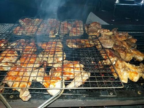 a bunch of different types of meat on a grill at New Kandy Residence in Kandy