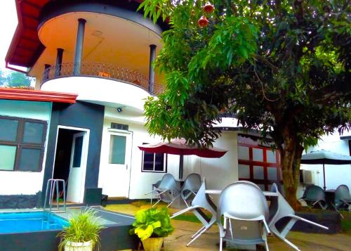 a group of chairs sitting in front of a house at New Kandy Residence in Kandy