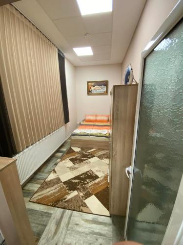 an empty corridor with a shower in a room at Apartments DIEM in Samokov