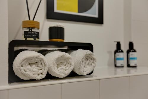 a bunch of rolled towels sitting on a counter at Central London - The Shoreditch, Angel, Old Street Apartment in London