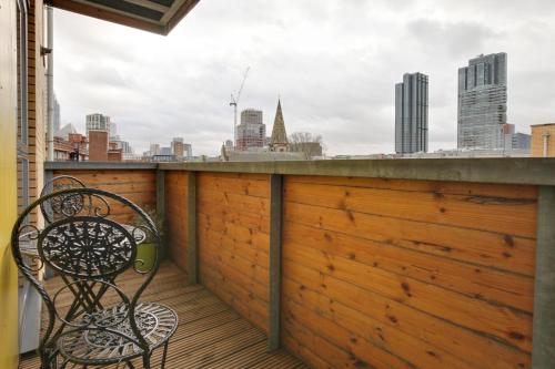 a bench on a balcony with a view of the city at Central London - The Shoreditch, Angel, Old Street Apartment in London